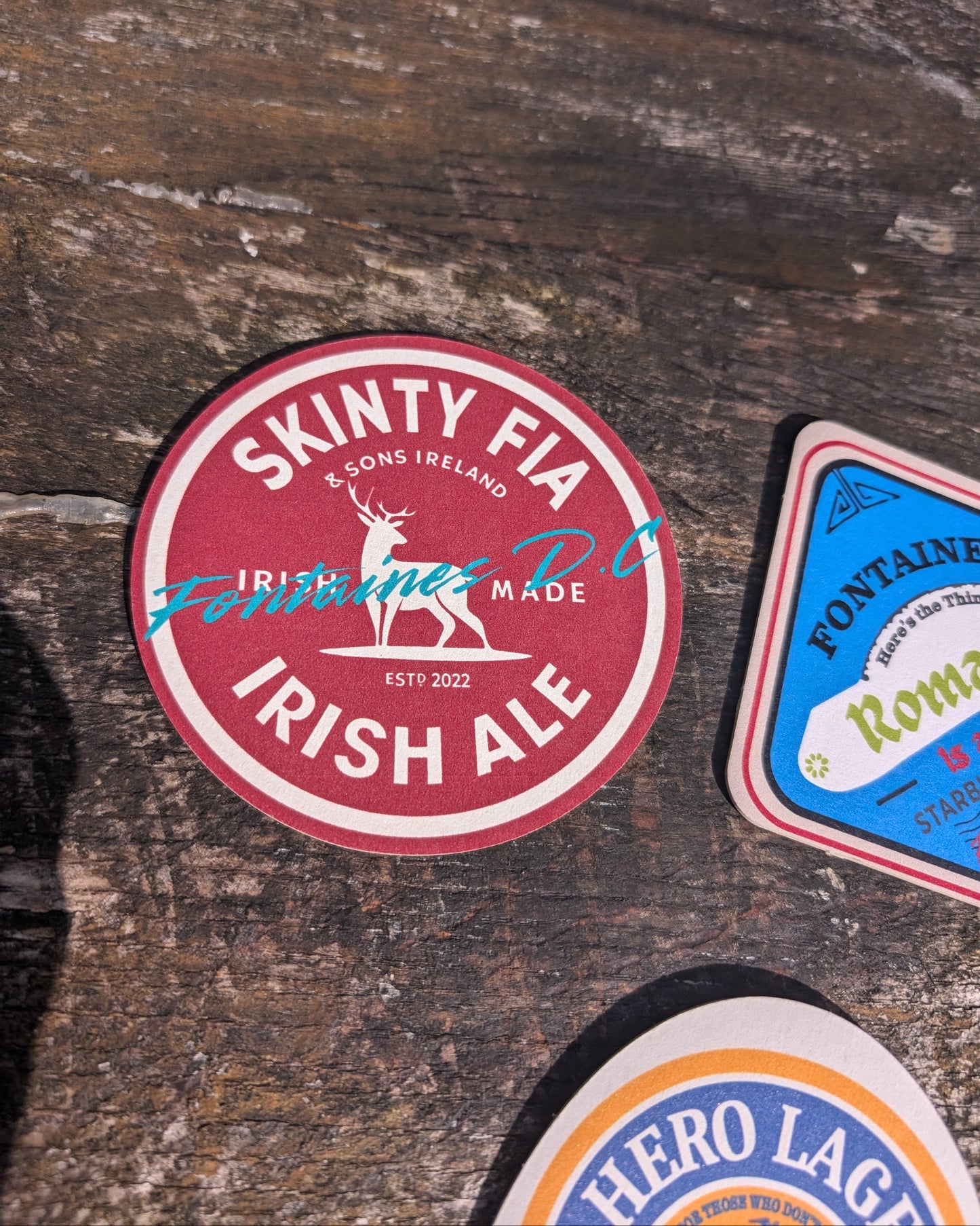 Skinty Fia Irish Ale label on a wooden surface with other labels.